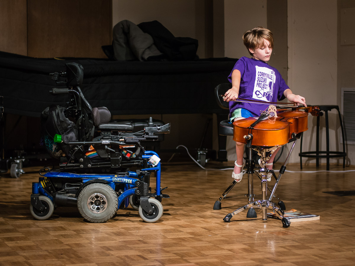 Young girl playing the cello adaptively
